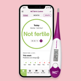 Natural Cycles App and thermometer showing 'not fertile' on phone screen