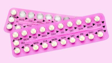 A pink pill packet on a pink background