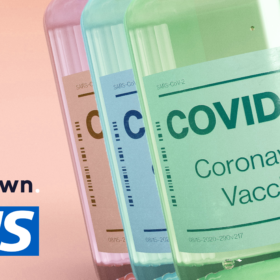 The Lowdown and NHS logos with COVID-19 Vaccine bottles