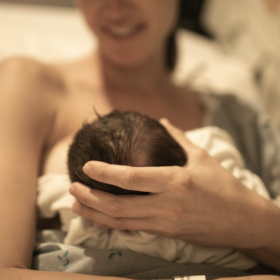 Woman breastfeeding newborn