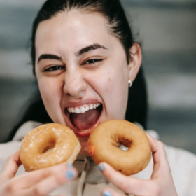 Woman holding two donuts
